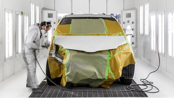 Collision Center Technician Painting a Vehicle | Thousand Oaks Toyota in Thousand Oaks CA